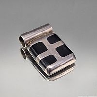 Front view of sterling pendant with black enamel squares