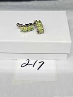 Front view showing both earrings and peridot stones