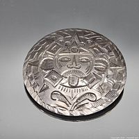 Front view of round sterling silver brooch showing full sun face design