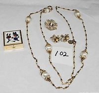 Full lot showing necklace, earrings, brooch, pill box
