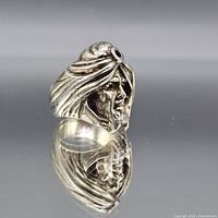 Front view of sculpted head ring showing design detail and patina