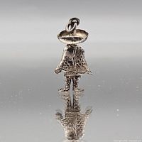 full view of standing figure charm front, jump ring on hat