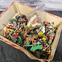 Boxful of assorted plastic toy soldiers, horses, bases