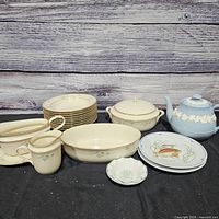 Group shot of all dinnerware pieces on black cloth