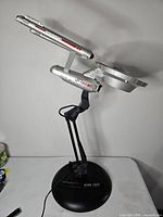 Full view of lamp showing USS Enterprise model on adjustable arm and base