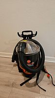 Front view of Hoover Commercial Shoulder Vac Pro backpack vacuum with hose