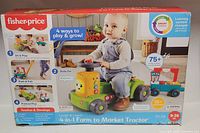 Front of boxed Fisher-Price Laugh & Learn 4-in-1 Farm to Market Tractor