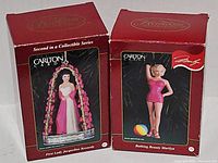 Two boxed Carlton Cards ornaments side by side
