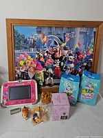 Group shot showing framed print, VTech tablet, snow globe box, Squishmallows packs, small figures