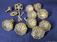 Group view of all hardware pieces including glass knobs, brass knob, escutcheon and screws