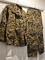 Shirt and pants hanging side by side displaying full fronts