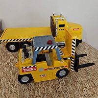 Forklift front view with flatbed truck behind