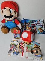 Group photo of all items including plush, diecasts, fabric, lanyard and boxed toy