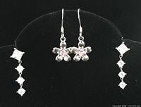 Front view showing both earring pairs on display stand