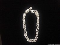 Full view of sterling silver bracelet on black background