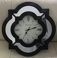 Front view of Westminster mirrored wall clock showing overall design and shape