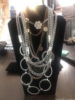 Full view of layered necklaces on display stand