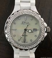 Front view of Daniel Steiger ceramic watch showing dial, stone bezel, date window