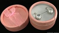 Closed pink case with pair of sterling silver earrings