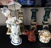 Group showing figurine, bookends, mosaic candlesticks, carved clay teapot, floral teapot