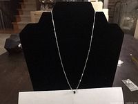 Full view of sterling silver chain necklace on display stand