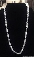 Full view of sterling silver Byzantine chain necklace on display bust