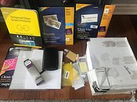 Overall view of all items including Avery packs, screen protector, Philips box, notebook and loose card sheets