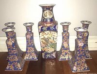 Front view of vase and six matching candlestick holders