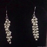 Full view of both sterling silver dangle earrings hanging