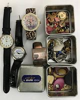 Overall view of four watches and three metal tins with jewelry parts