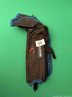 Closed fabric pouch displaying exterior and logo