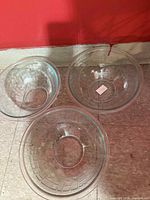 Top view of three clear glass textured Pyrex bowls