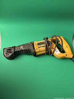 Full view of DeWalt reciprocating saw lying flat showing overall form and attached power cord