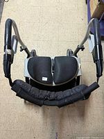 Top view showing split padded seats, handles, aluminum frame
