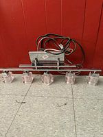 Full view of chrome light bar with five glass cube shades and wiring