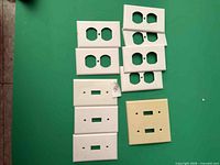 All ten wall plates laid out on green background