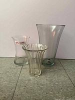 Front view of three clear glass vases