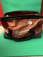 Front of Milwaukee red tool bag showing logo and handles