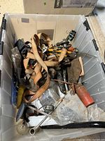 Overview of tote with mixed tools and hardware