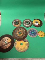 Group shot of all eight grinder discs on green backdrop