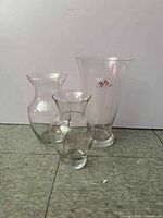 Three clear glass vases side by side