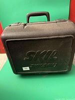 Front view of closed Skil Skilsaw case showing logo and handle