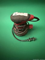 Front view of SKIL random orbit sander with coiled cord