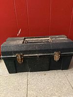 Closed toolbox front view showing latches and body