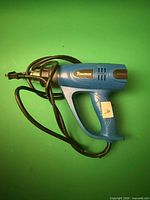 Left side view of Tooltech blue heat tool with cord visible