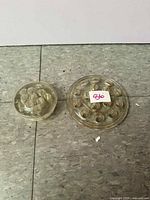 both glass flower frogs side by side