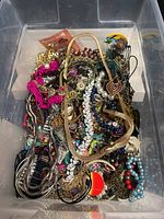 Overall view of bin filled with mixed jewelry items