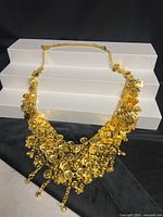 Full view of gold-tone chain belt laid flat