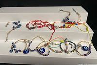 All ten bracelets displayed on white riser