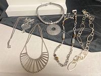 All five necklaces laid out showing overall styles